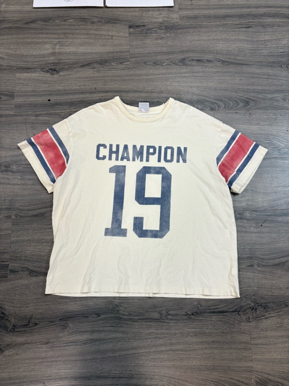 Champion Cream Short Sleeve Tee with Navy Graphic and Red Sleeve Stripes